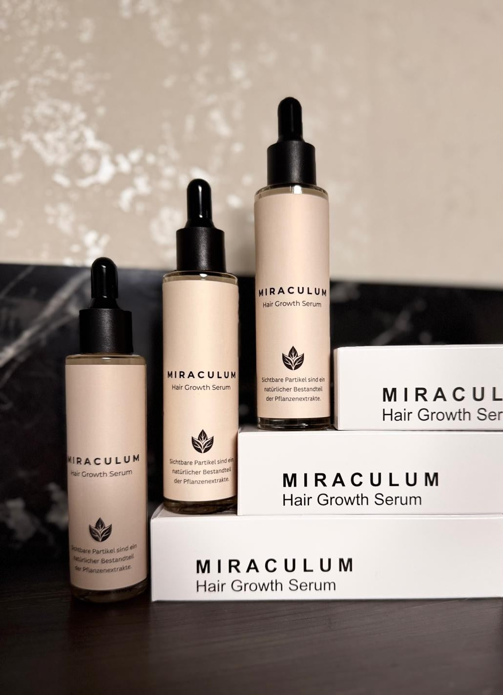 Dasifey MIRACULUM Haarserum – drei Flaschen mit Pipette vor gestapelten Produktboxen.