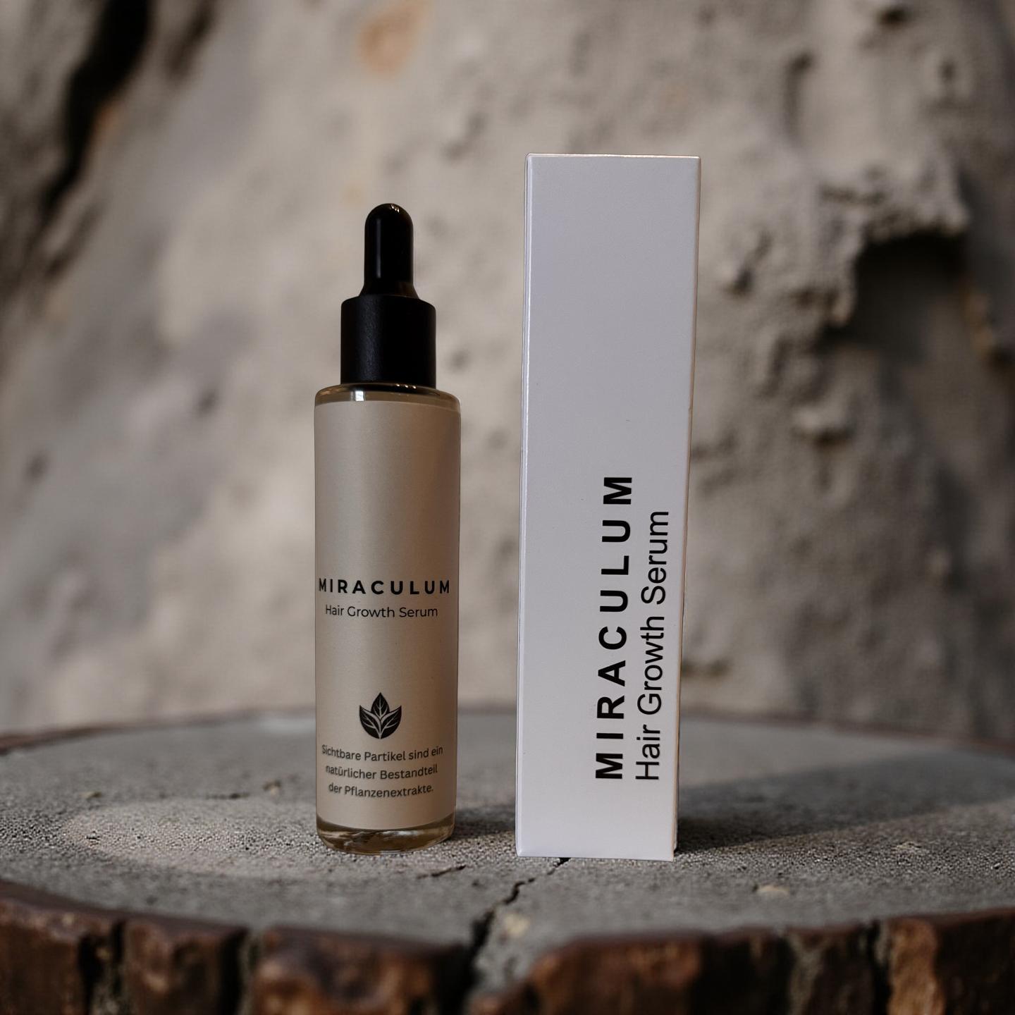 Dasifey MIRACULUM Haarserum – Flasche mit Pipette neben Verpackung vor steinigem Hintergrund.