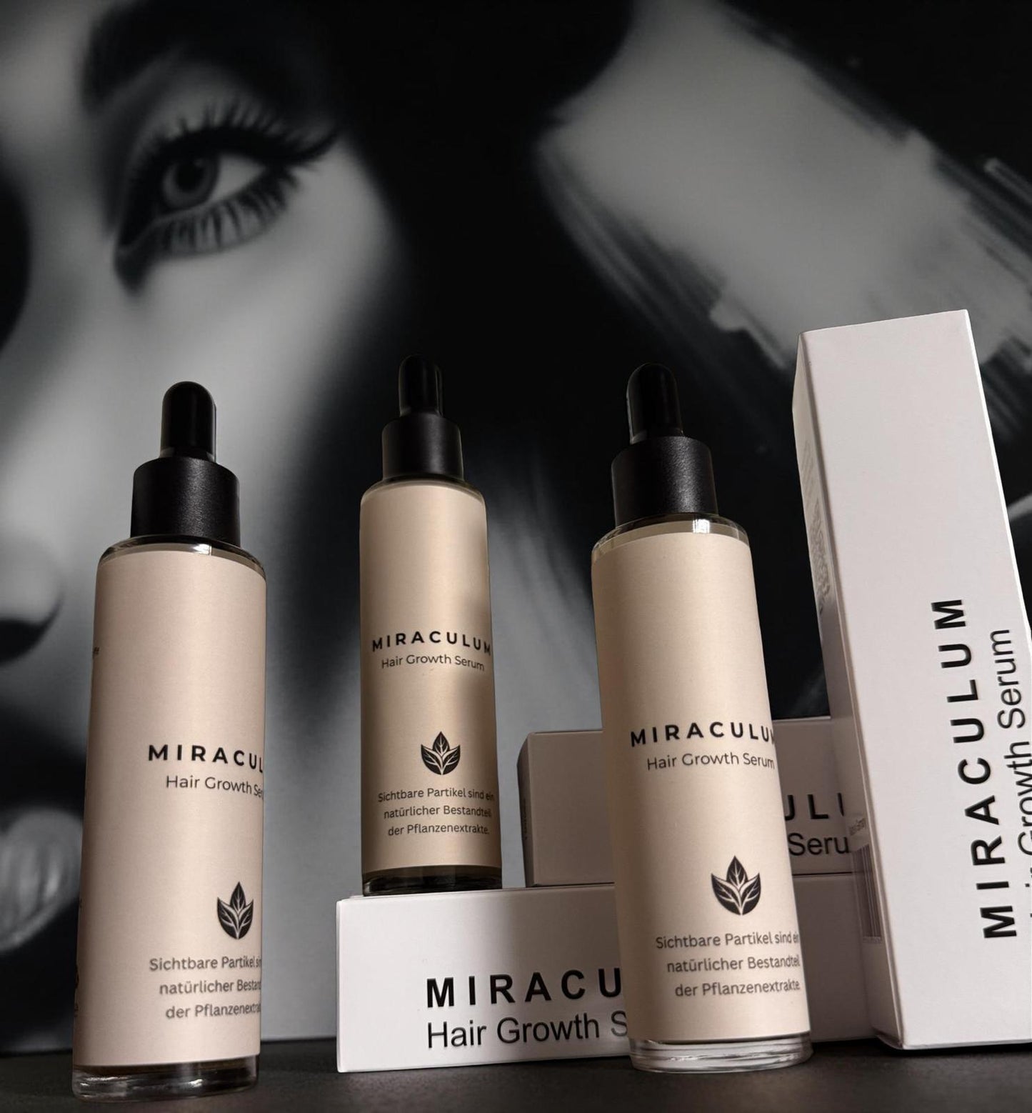 Dasifey MIRACULUM Haarserum – drei Flaschen mit Pipette und Verpackungen, Produktfoto vor schwarz-weißem Hintergrund.